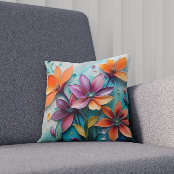 Cushion with stylized flowers in pastel tones on light blue background on sofa