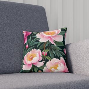 Floral cushion showcasing pink peonies on a dark leafy background on sofa