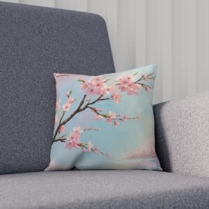 Soft pink cherry blossoms on cushion with sky blue background on sofa