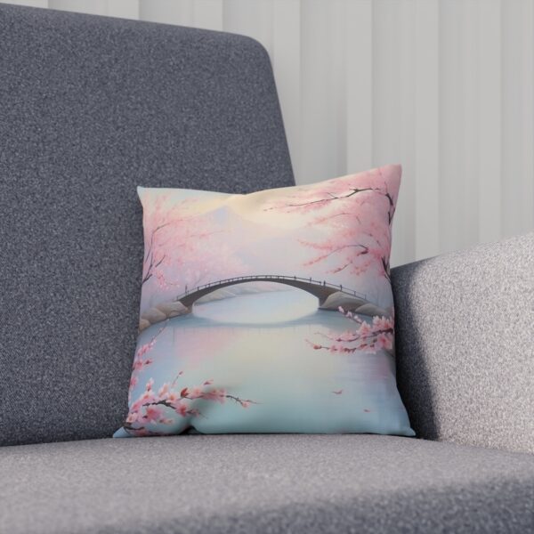 Cushion with cherry blossom and bridge scene on grey sofa