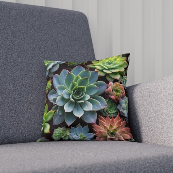 Cushion with large blue succulent and assorted greenery on sofa