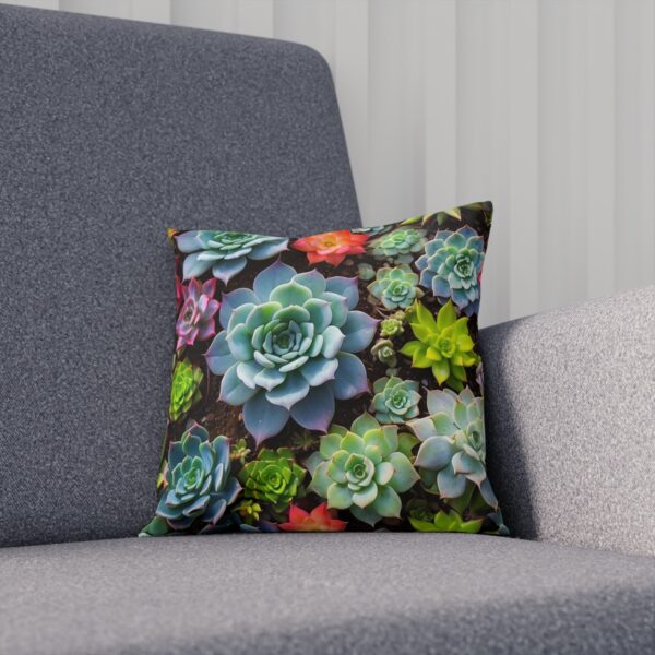 Decorative cushion with vibrant succulent design on grey sofa