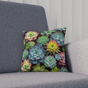 Cushion with colorful succulent arrangement on dark background on sofa