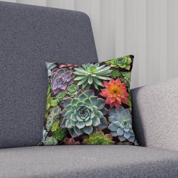 Cushion with a variety of green and red succulents on sofa