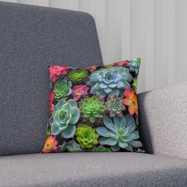 Succulent plants cushion with vibrant colors on grey sofa