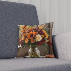 Cushion with a vase of autumn flowers on a grey sofa