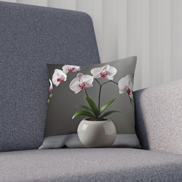 Dark cushion with a white orchid in a modern pot