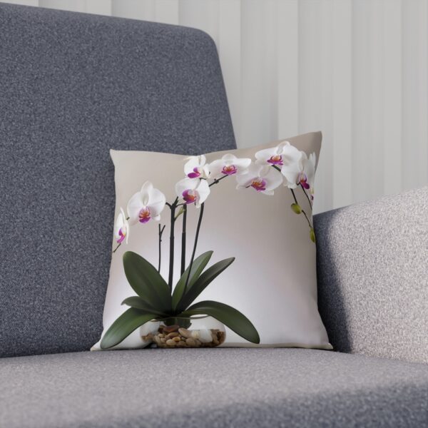 Cushion with white orchid and stones on a neutral background