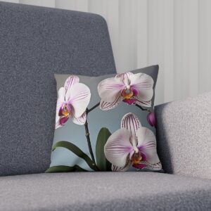 White and pink orchids on a cushion with a gray background