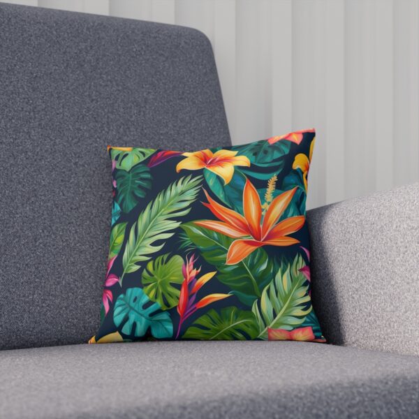 Cushion with exotic tropical flowers and lush green leaves