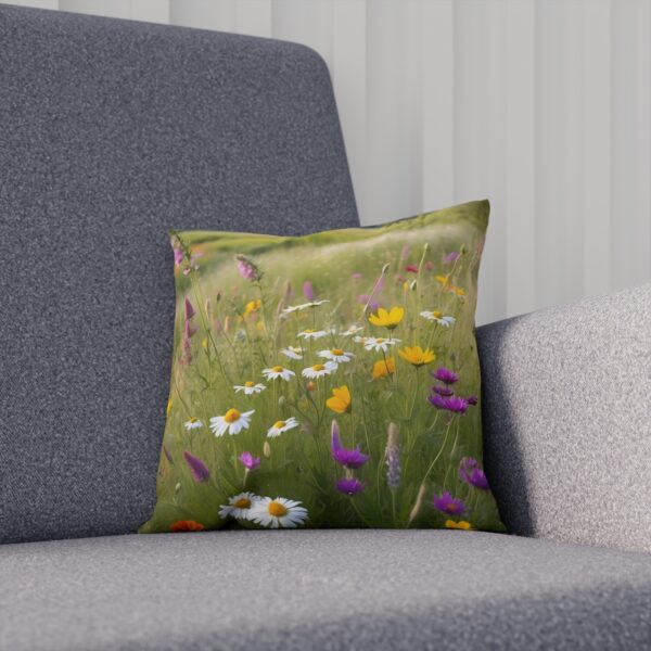 Cushion with a soft-focus meadow of wildflowers and daisies