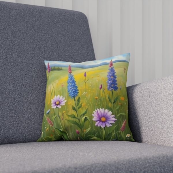 Cushion with colorful wildflowers against a bright meadow background