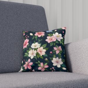 Cushion with pink and white flowers on a dark background