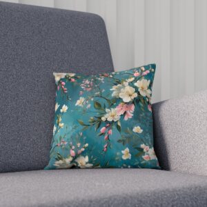 Floral cushion with pink blossoms on teal background