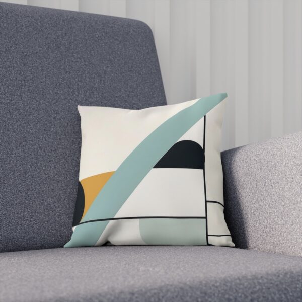 Modern cushion with teal and mustard geometric shapes