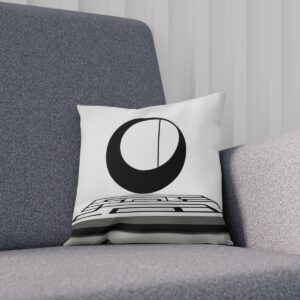 Cushion with geometric black circle design on a gray sofa