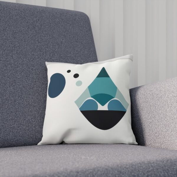 Minimalist white cushion with blue geometric shapes on chair