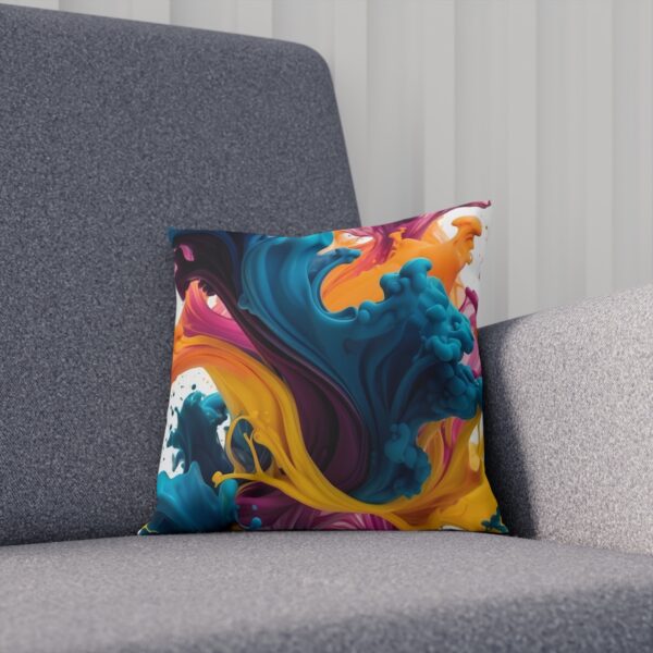 Vibrant cushion with abstract ink swirls on gray chair