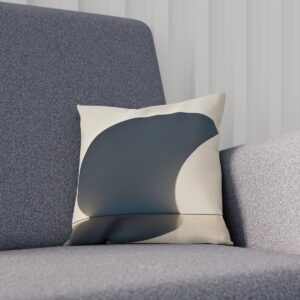 Modern cushion with abstract shadow design in gray tones on chair