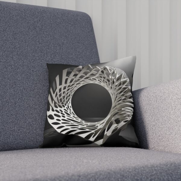 Black and white cushion with circular geometric pattern on chair