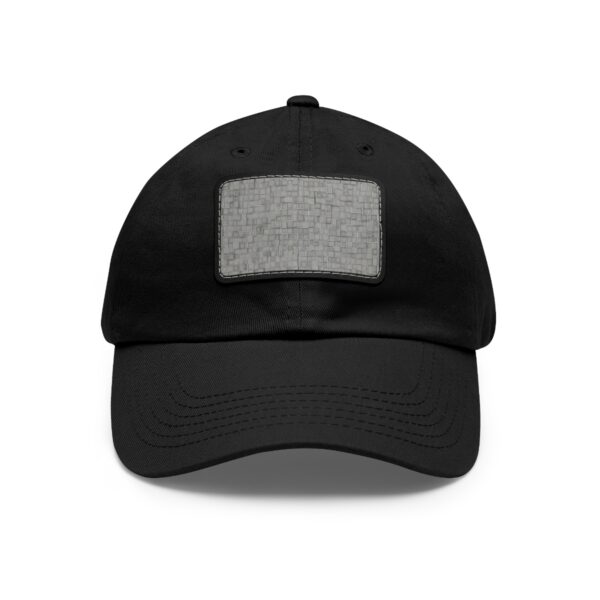 Black dad hat with a grey square leather patch featuring a scattered square design.