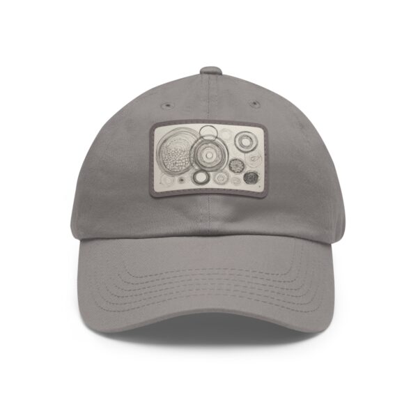 Dad Hat with stitched patch featuring a geometric design of concentric circles in neutral tones.