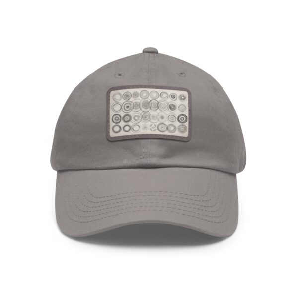 Dad Hat with stitched patch featuring a geometric design of variously sized circles in neutral tones.