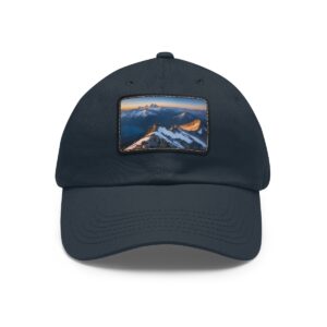 Navy dad hat with a twilight mountain range on a leather patch.