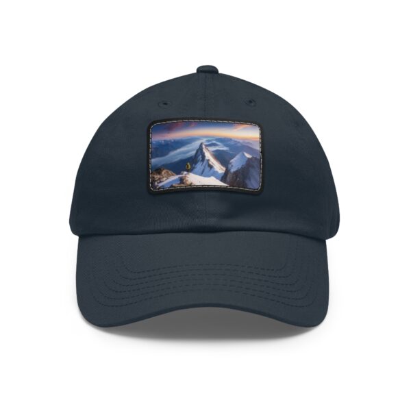 Navy dad hat with a sunset mountain scene on a leather patch.