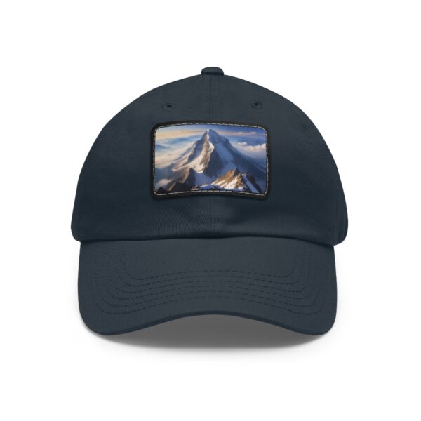 Navy dad hat with a leather patch depicting a serene mountain peak view.