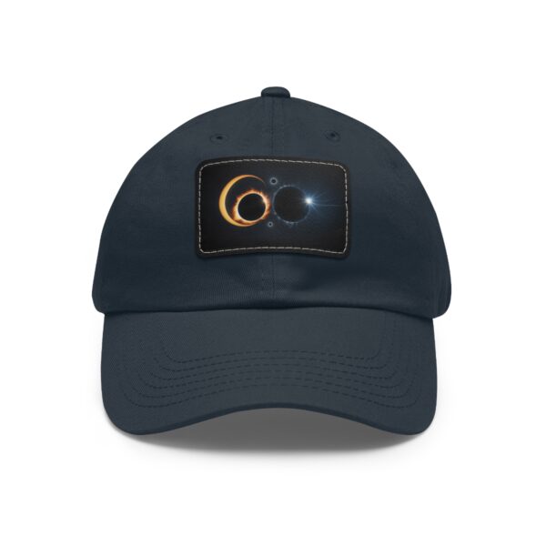 Dad Hat with stitched patch featuring a cosmic design of two overlapping solar eclipses with glowing effects.