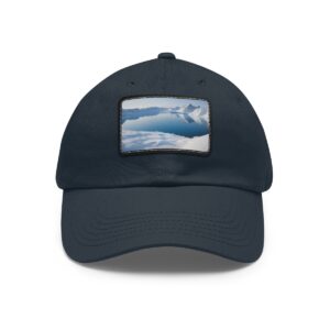 Dad Hat with stitched patch featuring a peaceful snowy mountain landscape with a clear sky.