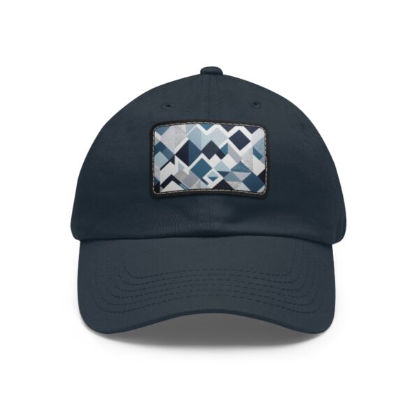 Dad Hat with stitched patch featuring a geometric pattern of overlapping triangles and rectangles in shades of blue, white, and gray.