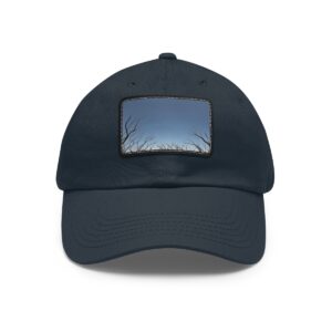 Dad Hat with stitched patch featuring a minimalist design of bare tree branches reaching towards a twilight sky.