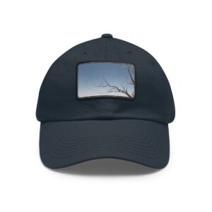 Dad Hat with stitched patch featuring a minimalist design of a bare tree branch against a clear sky.