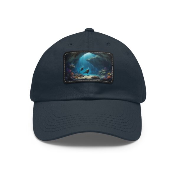 Dad Hat with rectangular patch featuring two divers exploring an underwater cave with coral and sunlight streaming in