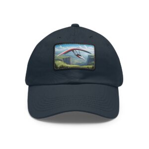 Dad Hat with rectangular patch featuring a hang glider soaring over a scenic mountain landscape