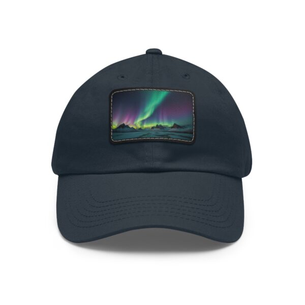 Dad Hat with rectangular patch showcasing vibrant Northern Lights over a silhouetted Arctic landscape