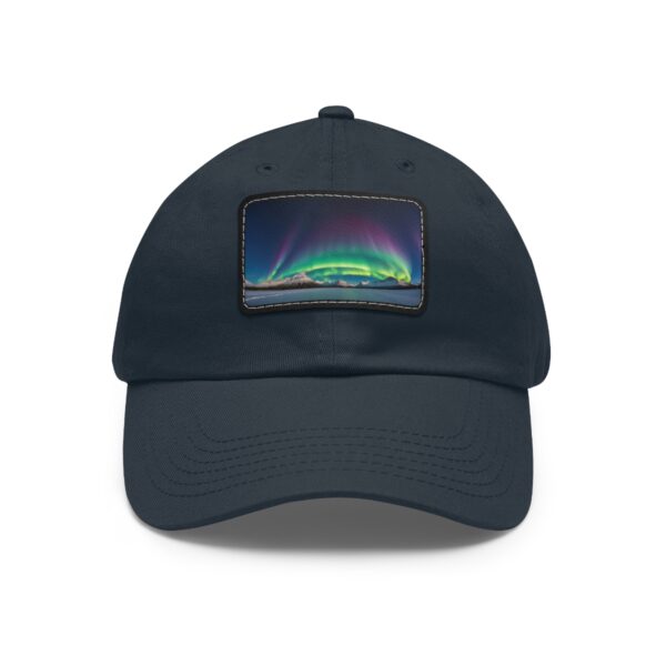 Dad Hat with rectangular patch featuring a brilliant Northern Lights arc over a calm Arctic landscape