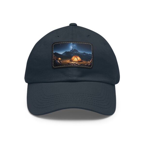 Dad Hat with rectangular patch featuring a glowing tent set in a mountain valley under a starry night sky