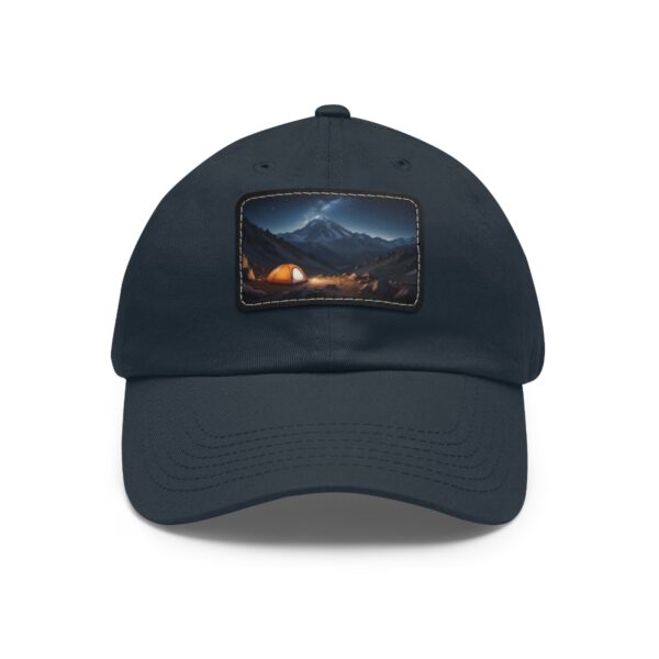 Dad Hat with rectangular patch featuring a glowing tent in a mountain valley under a starry night sky with mountains