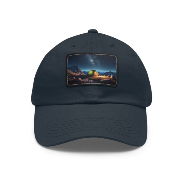 Dad Hat with rectangular patch featuring a glowing tent under a starry night sky with mountains in the background