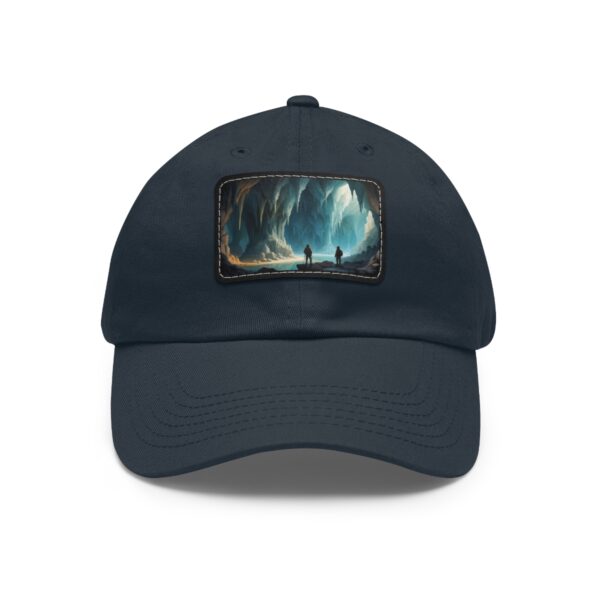 Dad Hat with rectangular patch featuring two explorers standing in a vast, illuminated cave with glowing walls