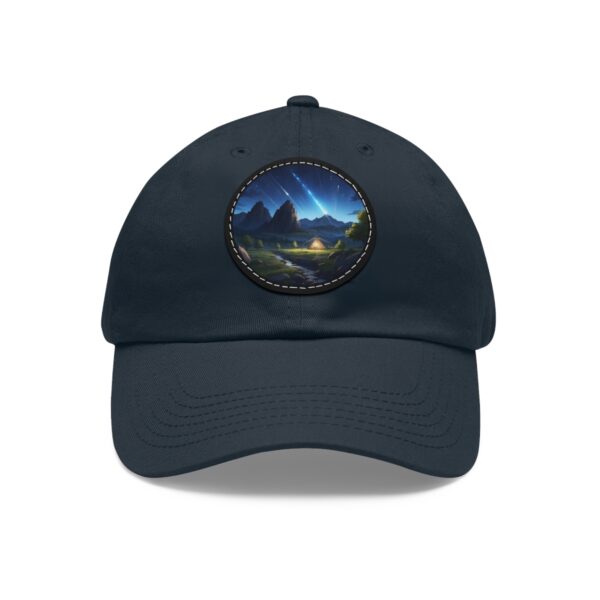 Dad Hat with round patch featuring a comet streaking across the sky above a serene mountain landscape with a glowing lake