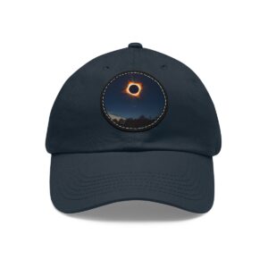 Dad Hat featuring a design of a solar eclipse with a glowing ring in a dark sky over a landscape on front