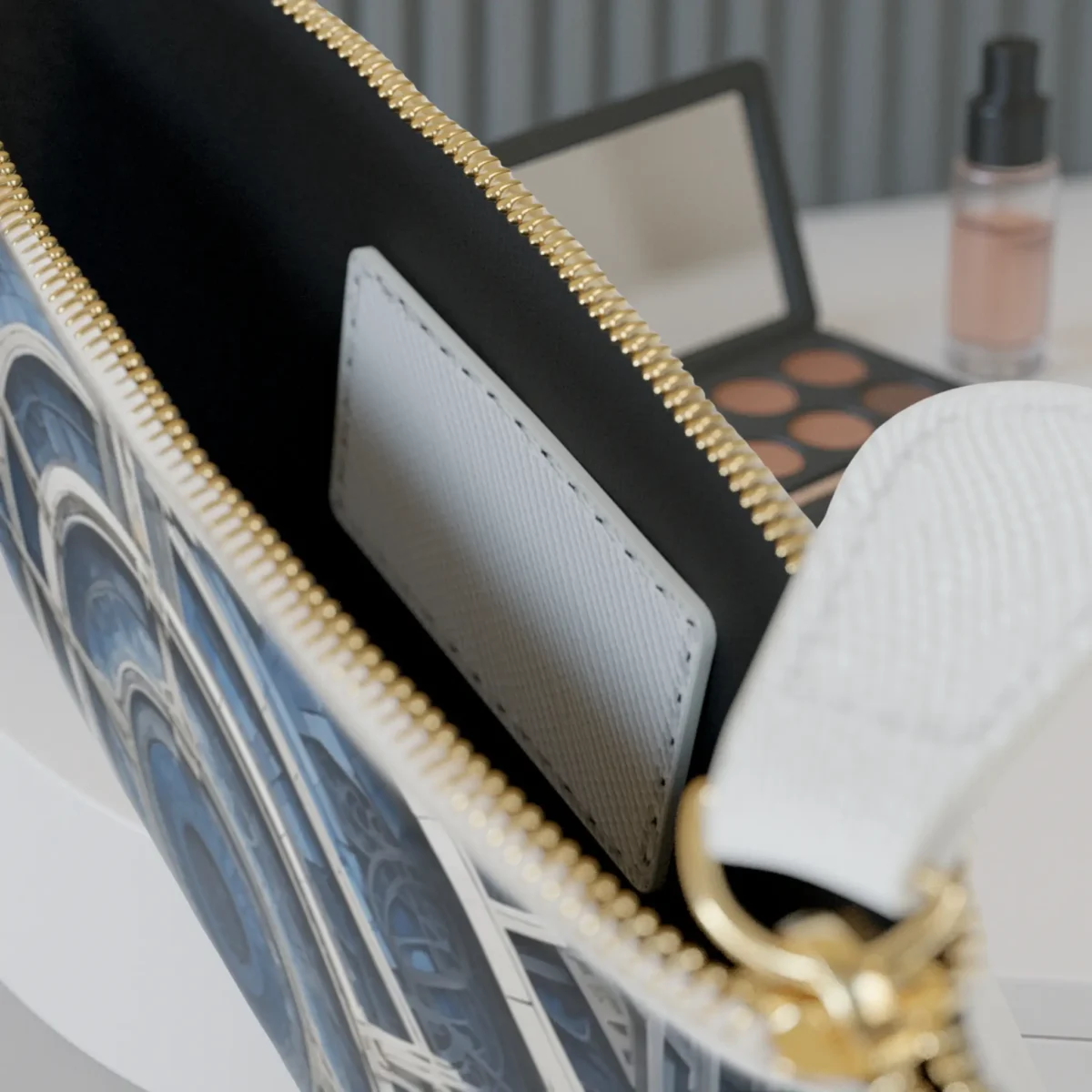 Close-up of architectural design clutch bag with open zipper showing inner pocket