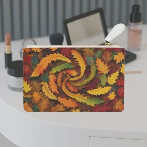 Mini clutch bag with a swirling autumn leaves pattern placed on a makeup table