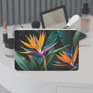 Mini clutch bag with a vivid bird of paradise flower design placed on a vanity table.