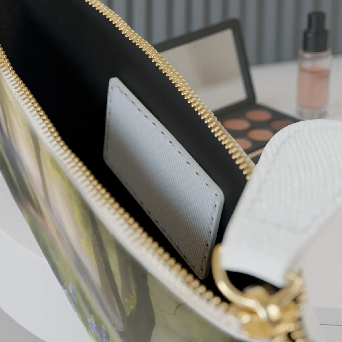 Close-up of the inside of the mini clutch bag showing the inner pocket and part of the floral forest print.