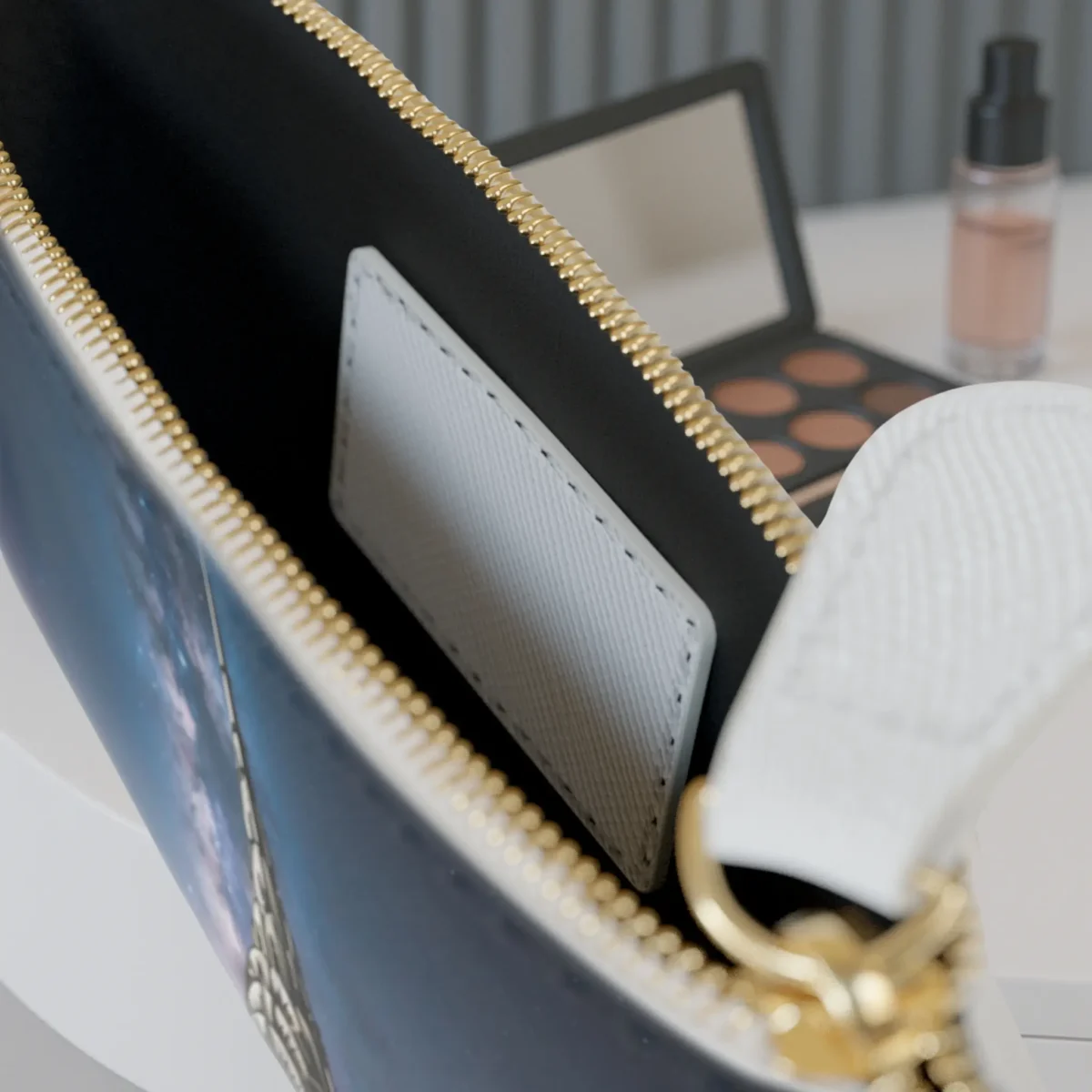Close-up of the inside of the mini clutch bag showing the inner pocket and a portion of the night cityscape design.